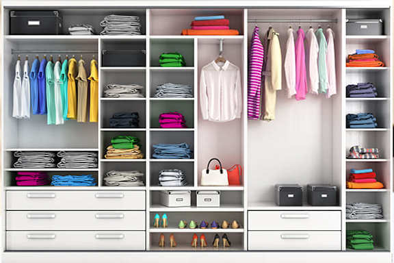 A well organized closet with clothes and accessories.
