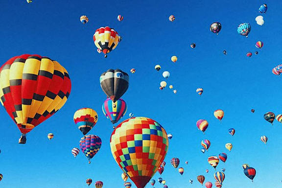 A group of hot air balloons in the sky.