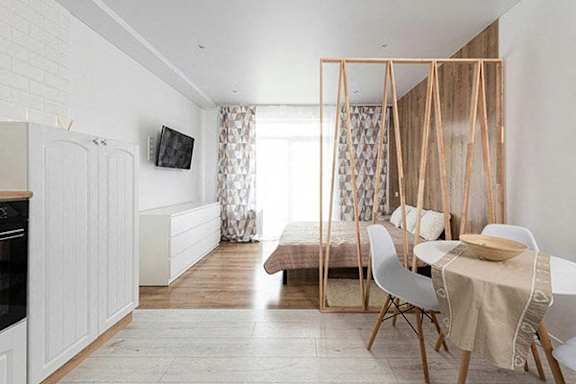 a room with a bed and a dining table and a