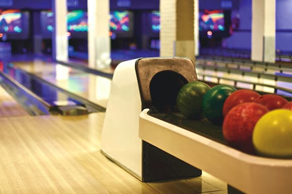 a bowling ball return at a bowling alley