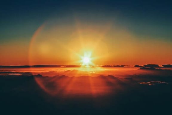 a sunrise over the mountains with the sun shining