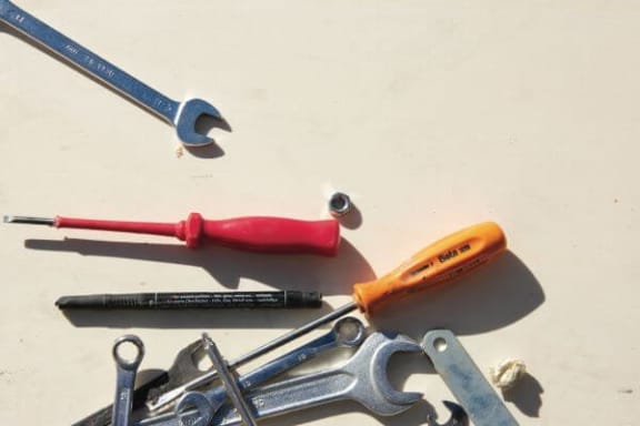 a pile of different types of tools on a table