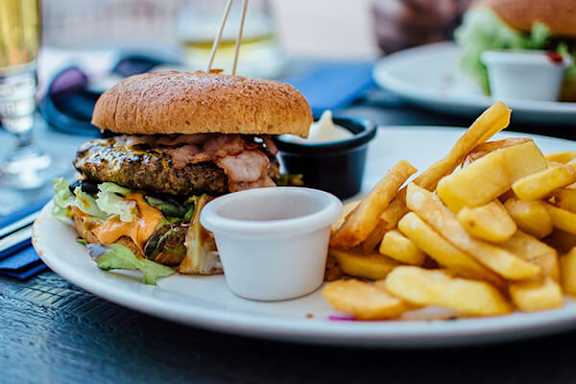 A plate with a burger and fries on it.