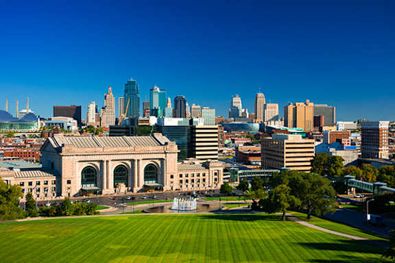 an aerial view of the city with a lawn and the city skyline