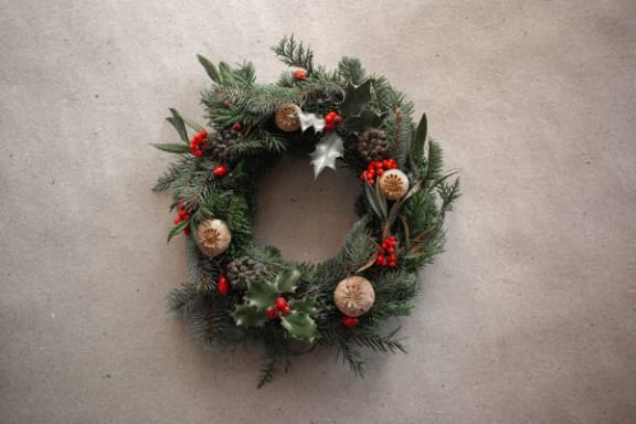 a christmas wreath on a white wall