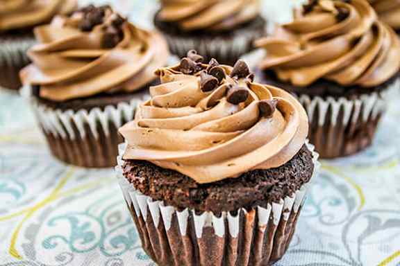 Chocolate cupcakes with chocolate chips on top.