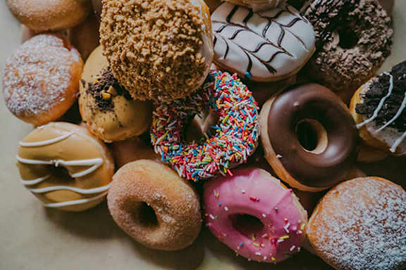 A variety of donuts with different toppings and flavors.