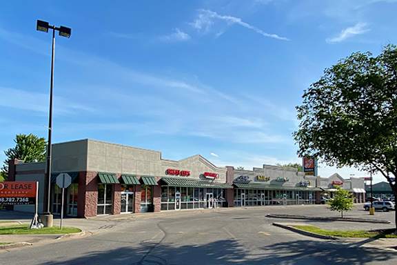 an empty parking lot in front of a shopping center