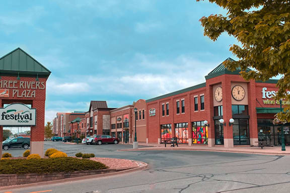a large brick building with a clock tower in front of it