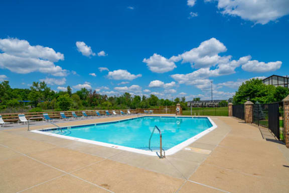 Lounge Chairs on Sundeck by Large Pool at Trappers Cove Apartments, Lansing, MI, 48910
