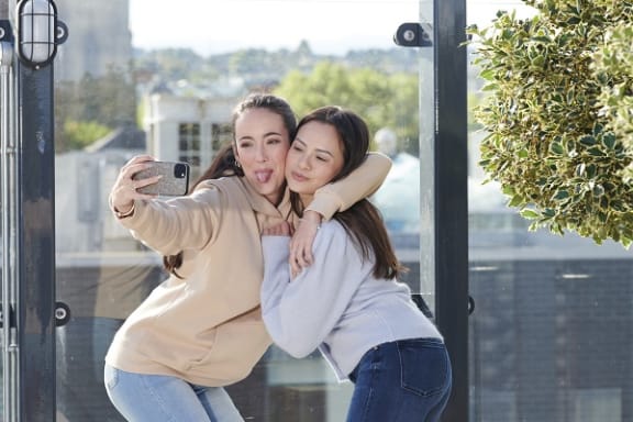a woman taking a photo of herself with a friend