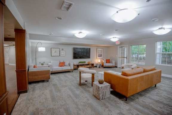 A spacious living room with a large couch and a television.