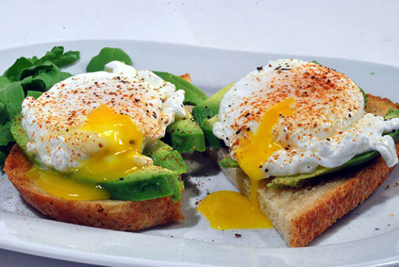 a plate with an egg on top of a piece of bread