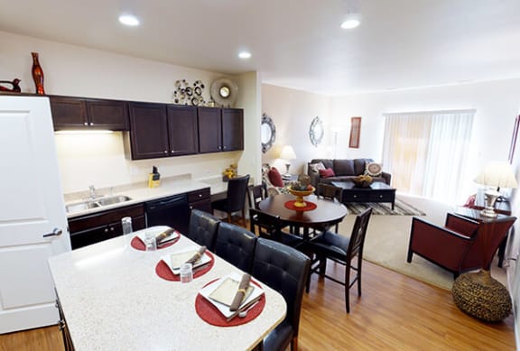 a kitchen and living room with a table and chairs