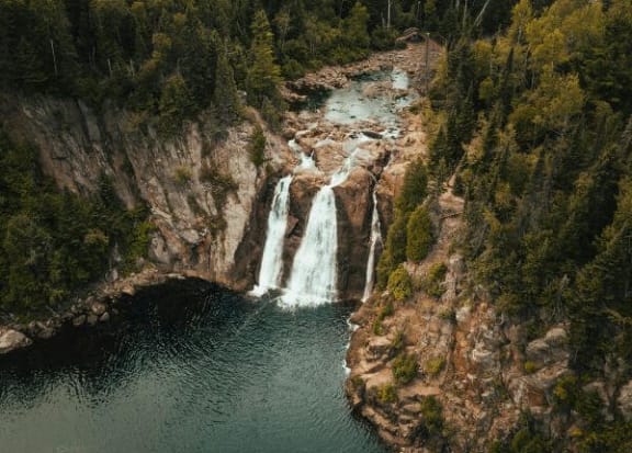 an aerial view of a waterfall in a river