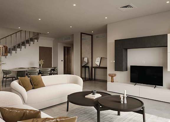 A modern living room with a white couch and a black coffee table.