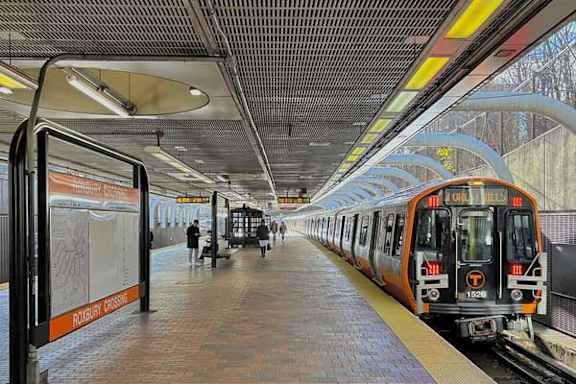 A train is at the station with a sign that says "Rochester".