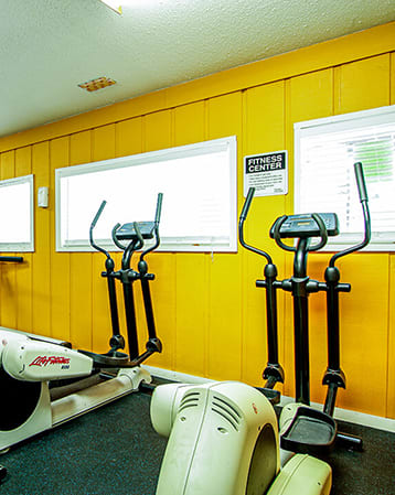 a room with a lot of exercise equipment in it