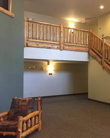 a wooden staircase in a building with a chair