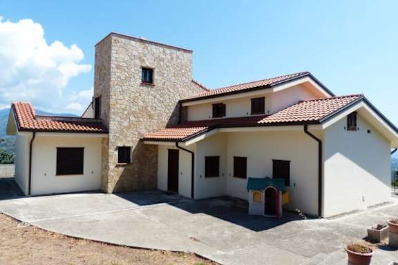 A house with a tower-like structure on the left side.
