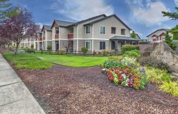 A large house with a well-maintained garden in front.