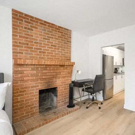 A room with a fireplace and a chair.