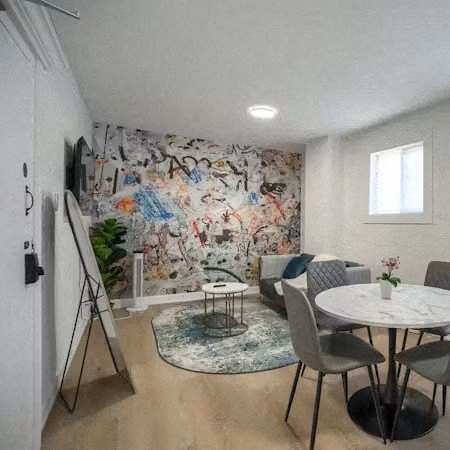 A dining room with a white table and chairs.