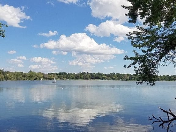 a large lake with a sail boat on it