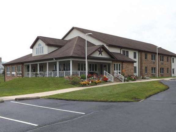 a large house with a porch and a lawn