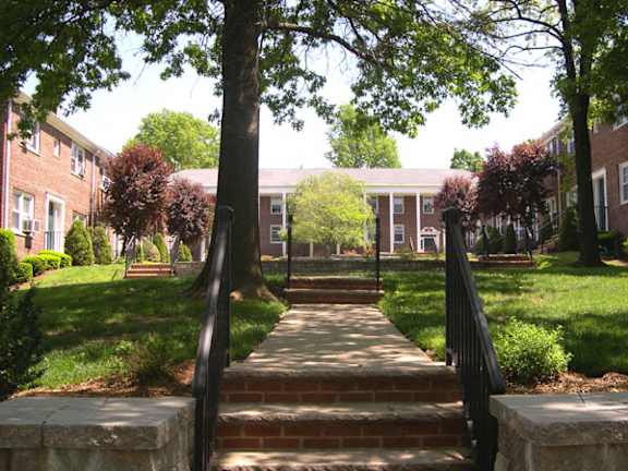 A brick pathway leads to a building entrance.