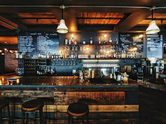 a bar with bar stools in a bar