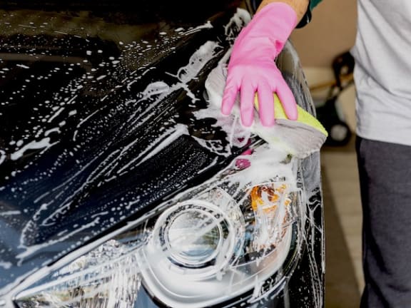 Person washing a car at Residences at the Green in Lakewood Ranch