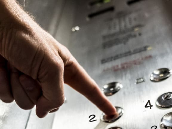 Person pressing elevator button