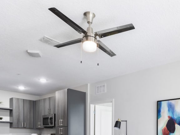 deluxe four-blade metallic ceiling fan in Residences at The Green living room