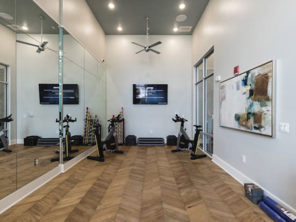 Fitness on Demand Studio with bikes, mirrors, & tv at Residences at the Green in Lakewood Ranch