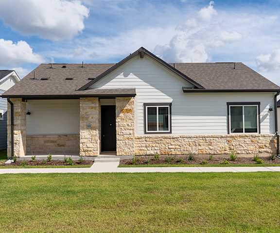 A house with a grey roof and a covered porch.
