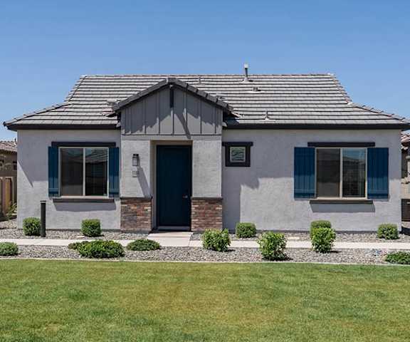 A house with a grey roof and a black door.
