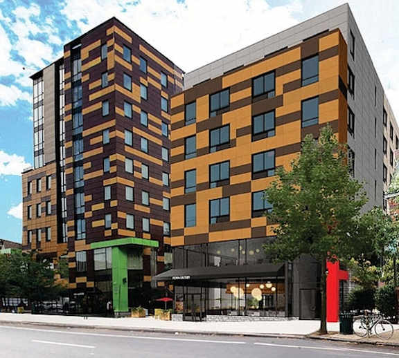 A modern multi-story building with a combination of brown, orange, and green colors.