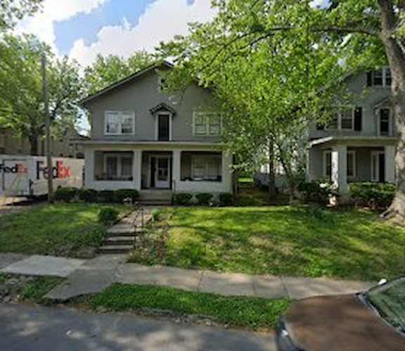 A house with a white front porch and a black door.
