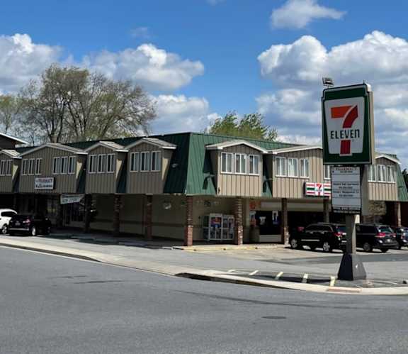 A 7 Eleven store is located in a strip mall.