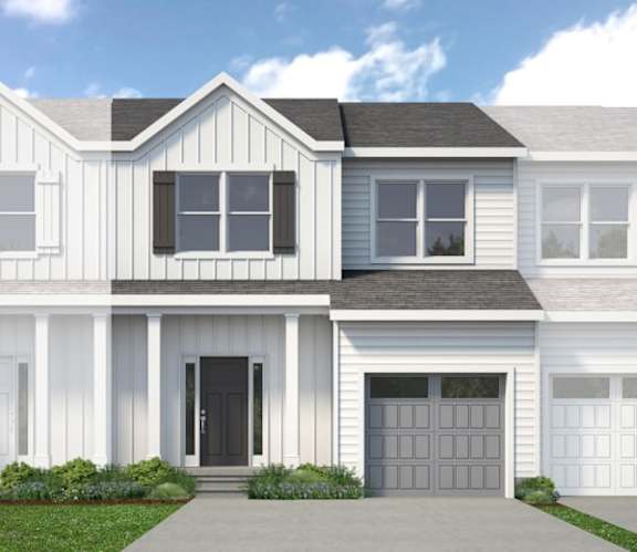 A modern two-story house with a black front door and white siding.