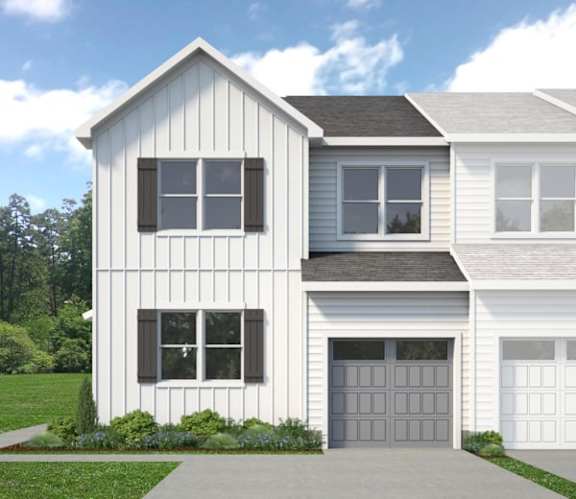 A modern two-story house with a garage.