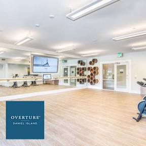 A gym with a blue logo that says Overture Daniel Island.