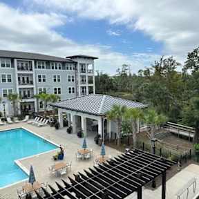 A large building with a pool in front of it.
