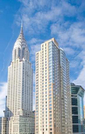 The image features a cityscape with tall buildings, including a distinctive spired building.