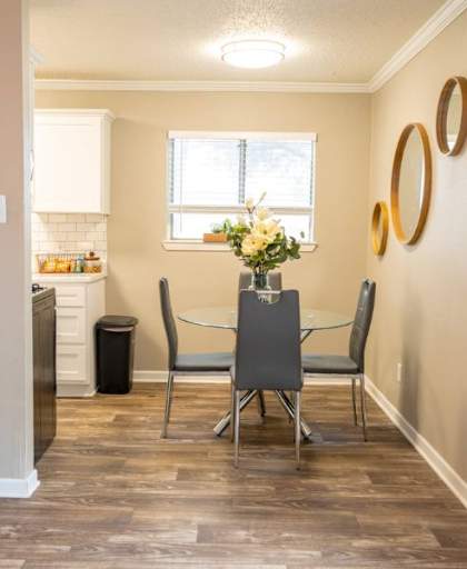 A dining room with a table and chairs.