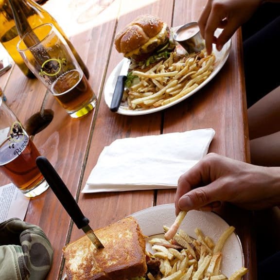 Burgers, french fries and beer being enjoy at Lower Burnside Lofts in Portland, OR 97214