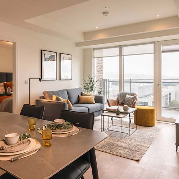 Two men playing ping pong in a well lit room.