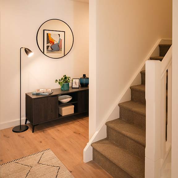 A modern living room with a dining table and chairs.