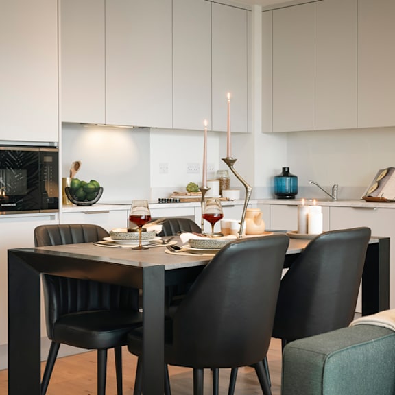 A modern dining room with a table set for two.